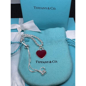 Tiffany & Co. small red enamel heart charm paired with a 925 bracelet